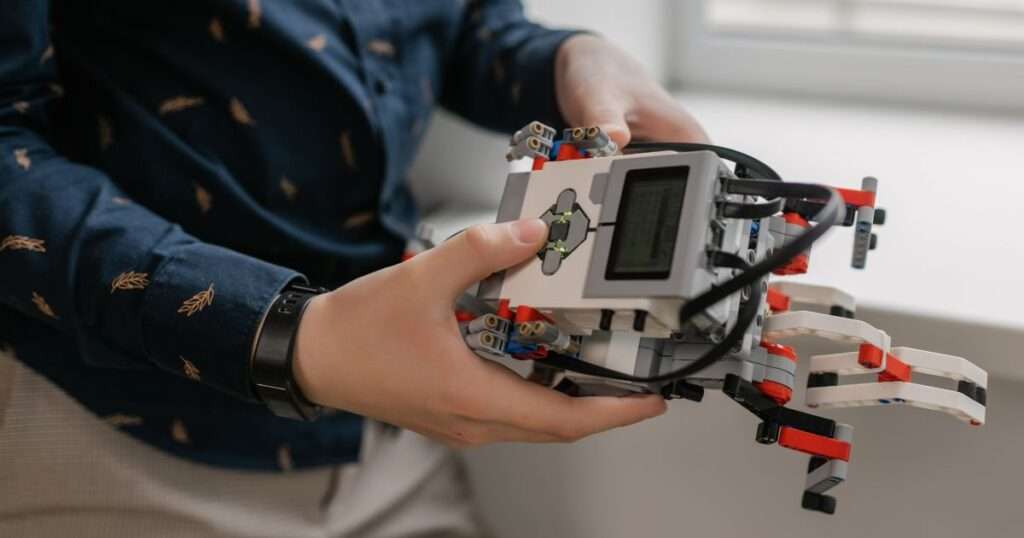 Person holding a lego mindstorm